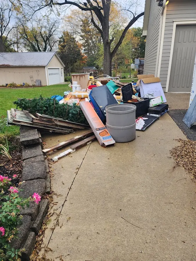 Dumpster being loaded with debris for 12 Yard Dumpster Rental in Kernersville